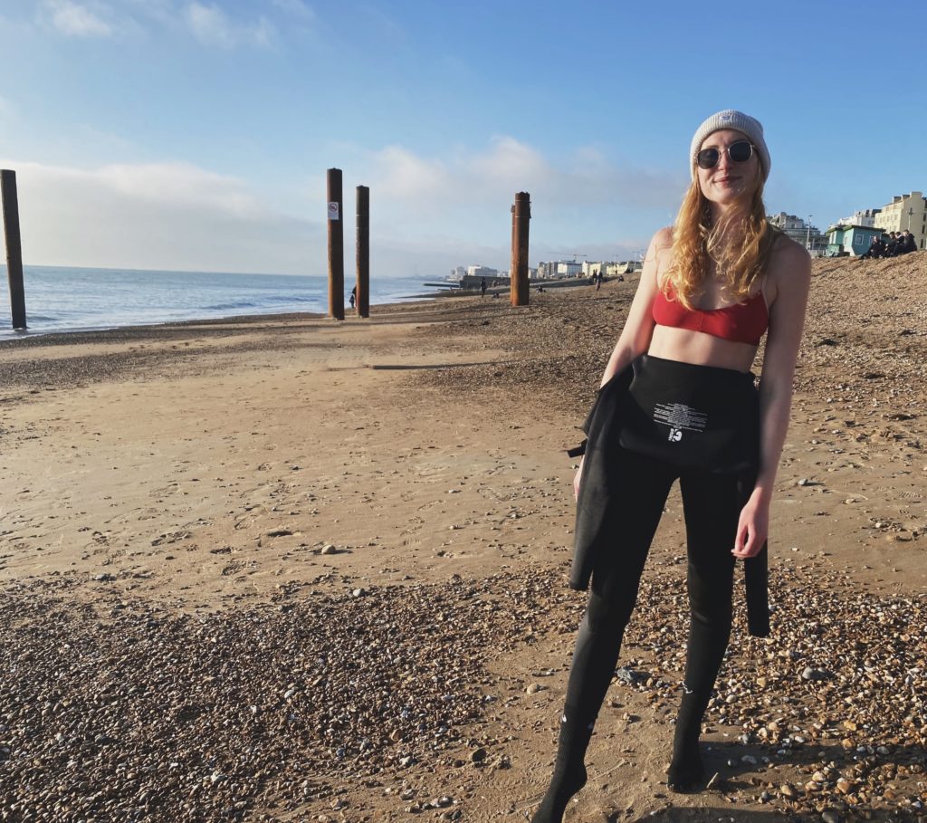 Blaise Harrison (receptionist / PT) standing on a beach in Brighton