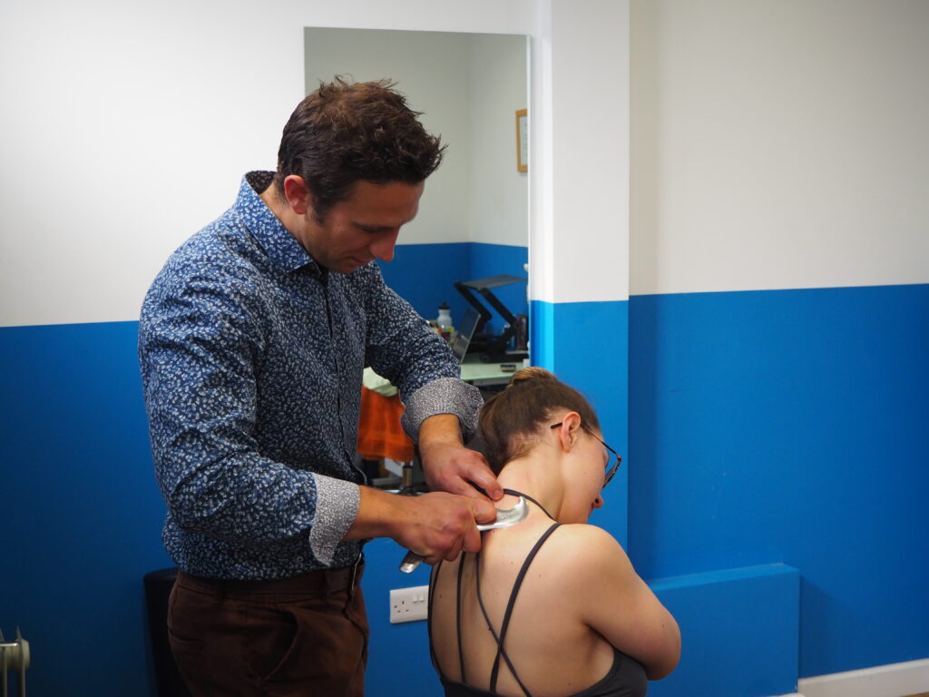 Man providing treatment at Chiropractic clinic in Brighton